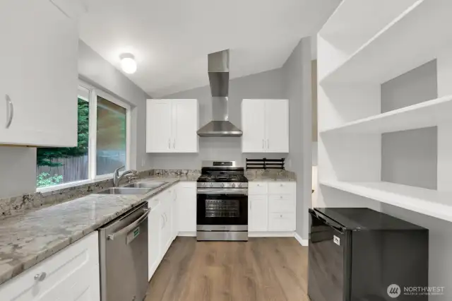 Kitchen features white shaker style cabinets, soft close with granite countertops.