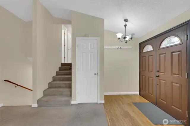 Front double doors and stairs to upper level.