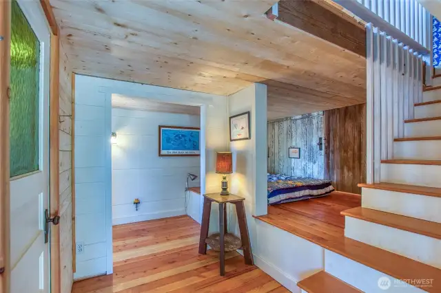 Second cabin with sleeping platform and 3/4 bath on the lower level. Kitchenette and great room is upstairs to the right.