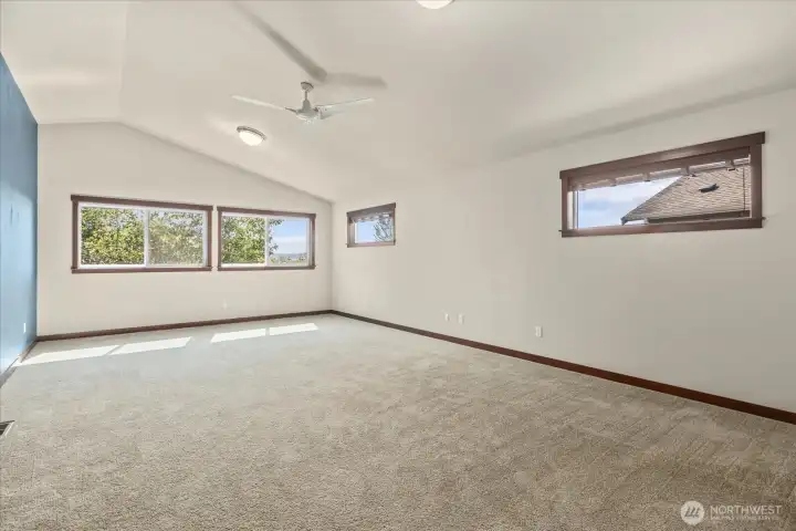 Whether movie nights or a home gym, this spacious flex room offers beautiful sunsets and natural privacy.