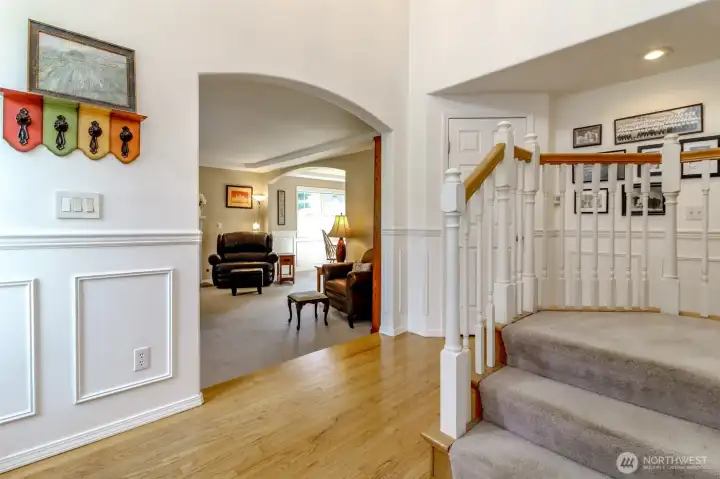A welcoming living room located just off the entry, accessed through a graceful arch doorway.