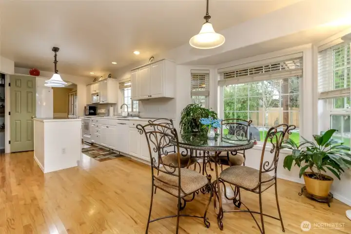Center-of-the-home eat-in kitchen that radiates warmth and welcome, wrapped in abundant natural light from large windows that set the mood for every meal and gathering, from casual breakfasts to festive entertaining.