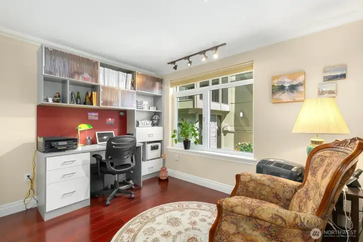The second bedroom is serviced by a full bath with tile accents.