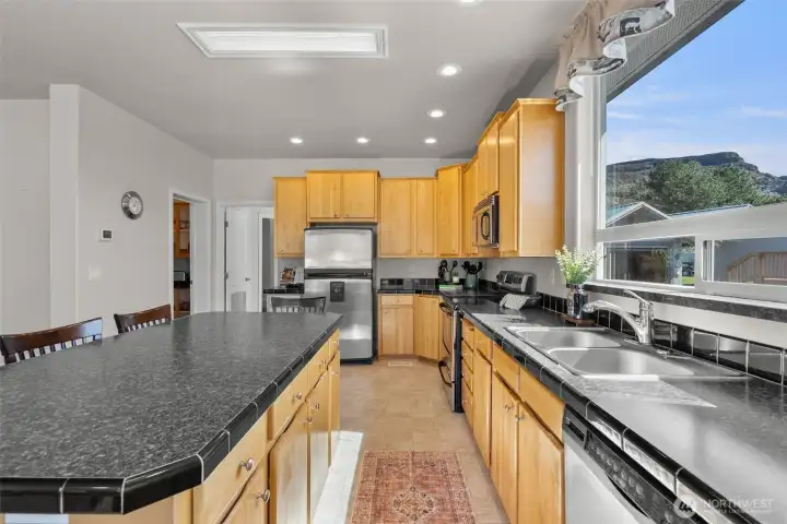 Kitchen has large window over the sink looking across to the little house and the skylights let in so much natural light.