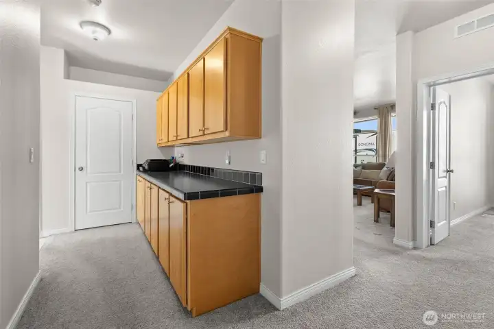 Hallway from Kitchen to the bedrooms.  More storage in these thoughtfully placed cabinets making use of this space for a 2nd pantry, bar set up, coffee station or just extra storage space for linens, dishes or games.