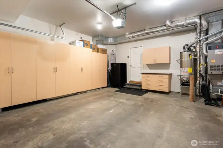Garage cabinetry with  work surface, & custom cabinet organizers.