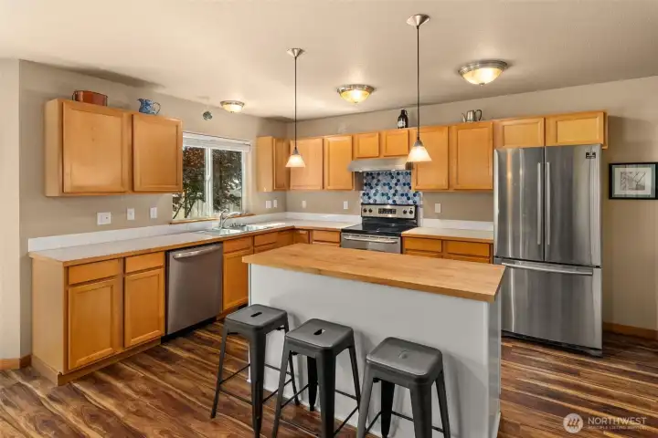 Kitchen offers bar seating, plenty of storage, and a convenient pantry