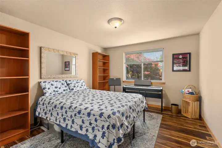 First bedroom upstairs is generously sized with views of the backyard