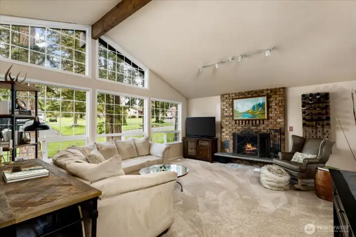 Spacious living room with vaulted ceilings and a cozy fireplace.