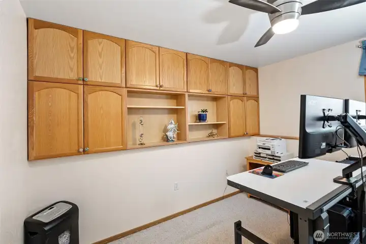Office area in family room with built in cabinets