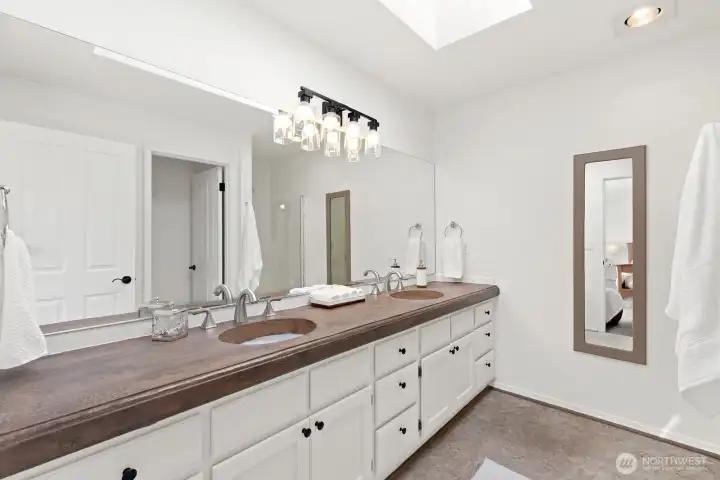 Primary ensuite bath with custom colored concrete vanity top.