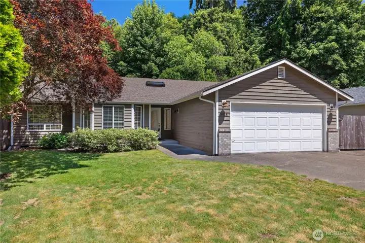Nestled in a beautifully landscaped setting, this home features quality cedar siding and enduring Northwest charm.