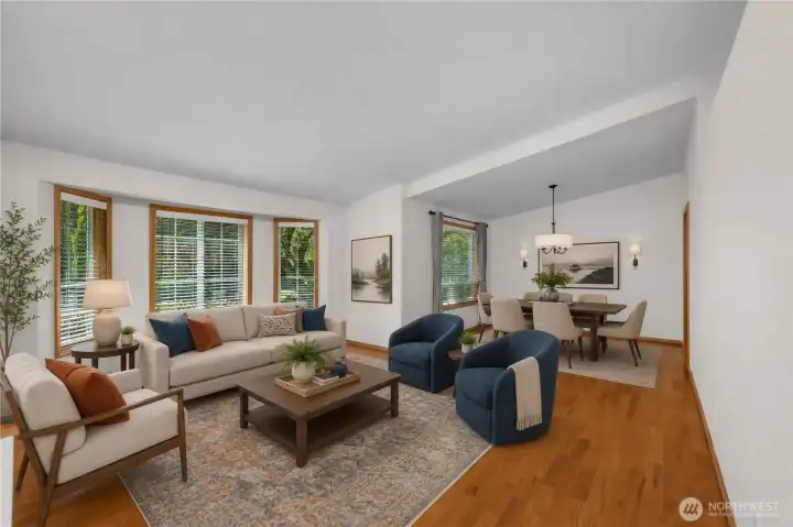 Soaring vaulted ceilings, rich hardwood floors, and beautifully crafted wood-trimmed windows create a warm and inviting living and dining space. Virtually staged.