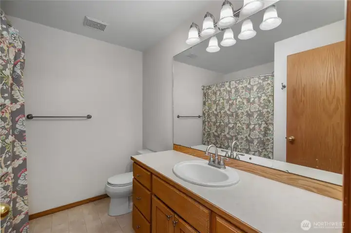 Main full bath with plenty of counter space.