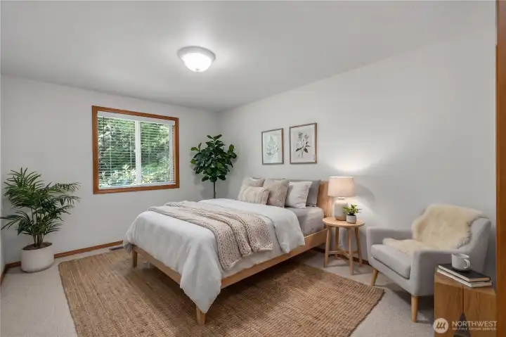 The third bedroom enjoys peaceful views of the private, beautifully landscaped backyard. Virtually staged.