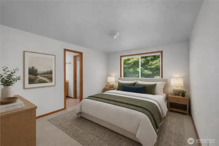 The private primary suite is a relaxing retreat, offering a full bath, walk-in closet, and peaceful views of the surrounding natural landscape. Virtually staged.