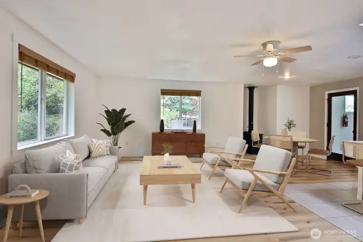 Luxury vinyl plank flooring, woodstove in the nook, ceiling fan...The French door leads to the laundry-storage area. Virtually staged. Luxury vinyl plank flooring, woodstove in the nook, ceiling fan...The French door leads to the laundry-storage area. Virtually staged.