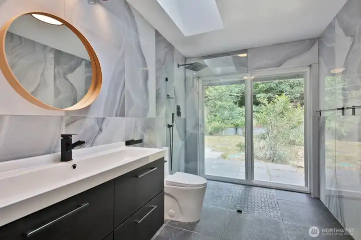 3/4 bath with glass wall shower...and slider to the exterior. The stone floors have radiant heat! 3/4 bath with glass wall shower...and slider to the exterior. The stone floors have radiant heat!