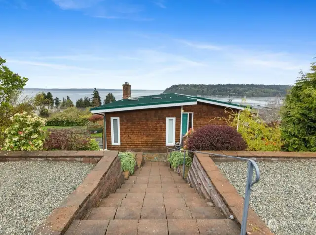 Stairs down to property with Puget Sound view in distance.