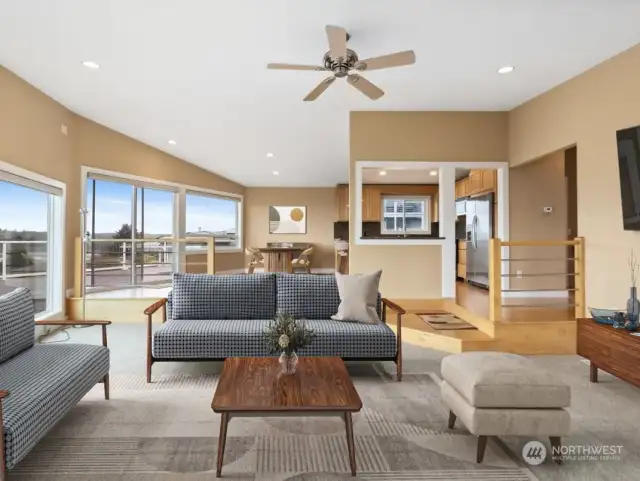 View from fireplace towards dining and kitchen spaces.