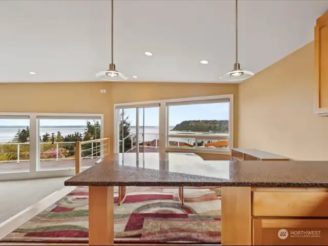 View from kitchen across dining area out to slider and the deck.