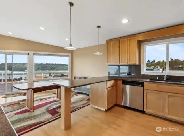 Granite countertops, maple cabinets with under cabinet lighting & thoughtfully placed pendant & spot lights to highlight focal points.