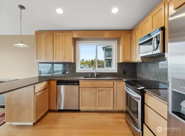 North view from entry to kitchen to window over sink, with light centered above it.