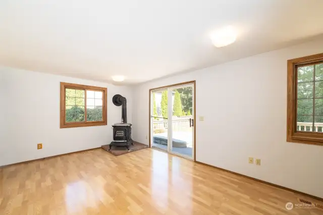Long Family Room off the Kitchen w/ Woodstove & Slider to back Deck.