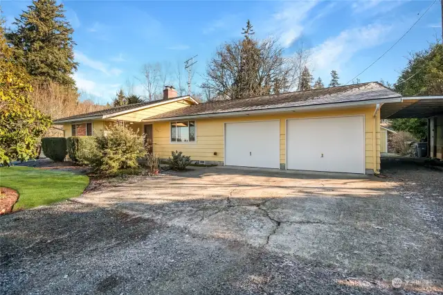 The 2-car garage and addtional attached carport provides plenty of covered parking, while the oversized driveway also offers more RV storage.