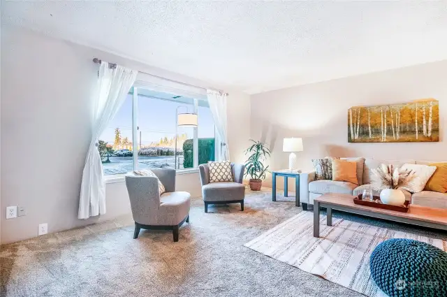 A slate entryway leads to the oversized living room with large window that views to the west.