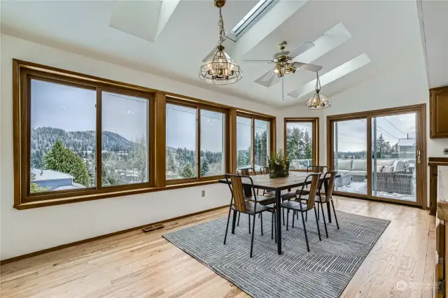 Rows of wrapped windows provide scenic views from the kitchen and casual dining area.