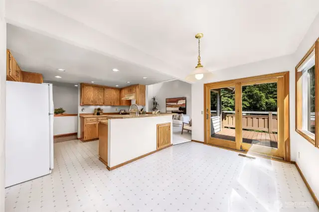 This angle showcases the flow from dining area to kitchen and living space. The open-concept design encourages easy movement and entertaining while preserving scenic outdoor views.