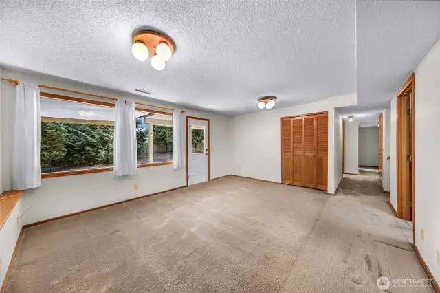 Alternate view of the lower bonus room highlights spacious dimensions, closet storage, and corridor access. Flexible design suits multiple lifestyle needs.