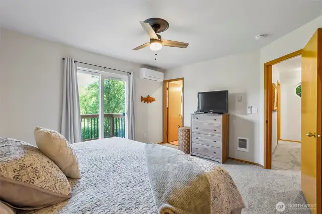 Another view of primary bedroom with slider to private deck