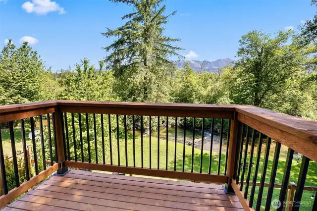Private deck off of primary bedroom with a view to creek.