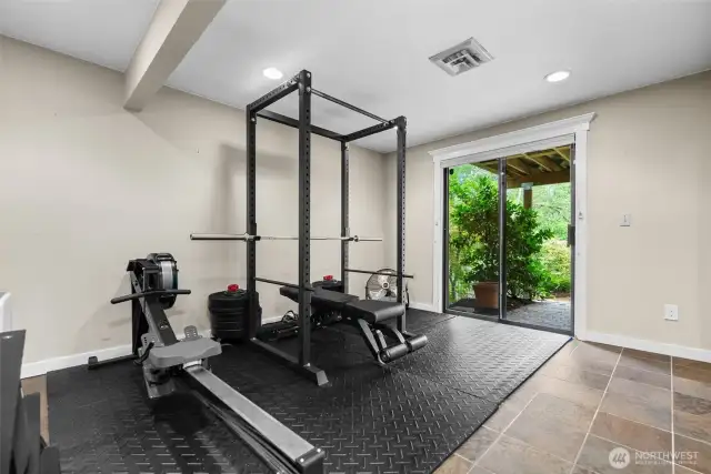 Lower level 3rd bedroom with heated floors and sliding door to patio