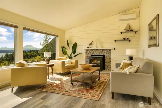 Huge windows face the views of Mt. Rainier and boats plying the sound. Fun fireplace with wooden board wall behind.