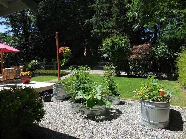 Round the Corner to the fenced back Yard Raised Veggie Beds and Relaxation Decks