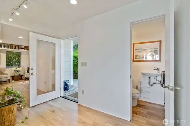 One of two entrances, this beautiful glass door lets in beautiful light. A half bathroom on the main level, perfect for guests.