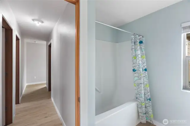Full bathroom upstairs at the end of the hallway. 2 bedrooms to the left and laundry room to the right.