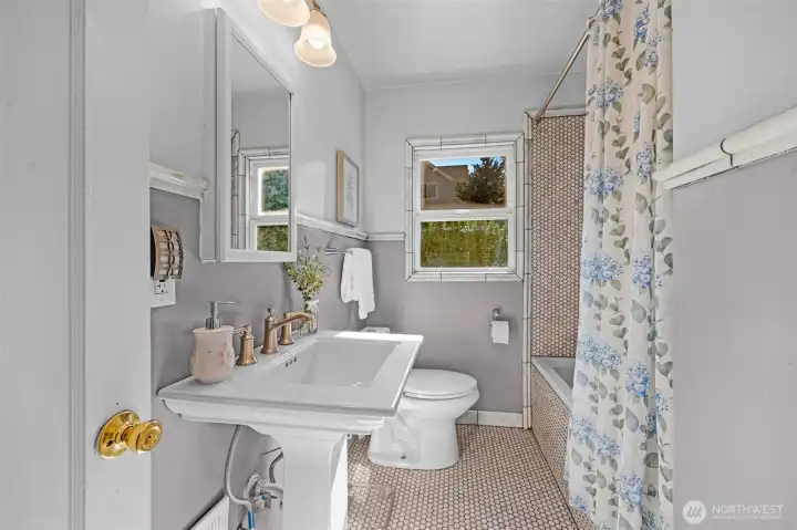 The bathroom has been updated with a timeless tile design.
