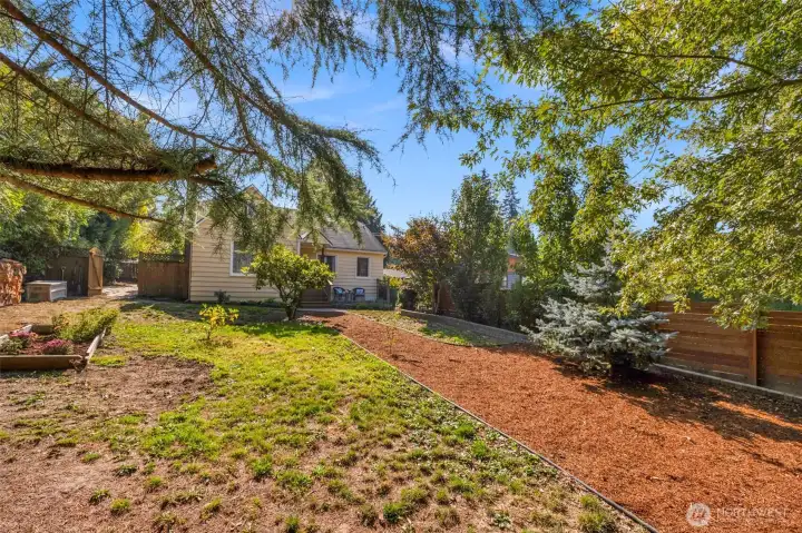 The front yard is spacious and can support garden beds or ample space to add a workshop or other detached structure
