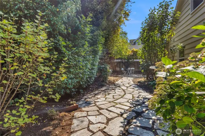 A beautiful yard area, includes a stone path and patio area perfect for relaxing outdoors.The large backyard or front yard is ideal for summer gatherings, pets, or play space.