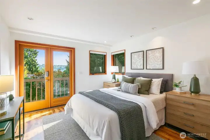 Primary bedroom has deck access to the hot tub and private backyard.