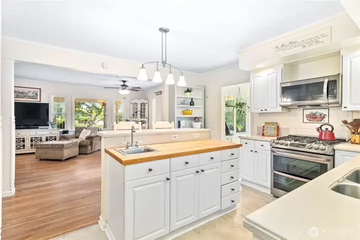 Kitchen looking toward living room, eat-in island w/butcher block & prep sink