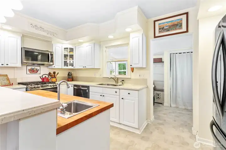 Spacious mud/laundry room w/access to back of home, pantry closet & utility sink