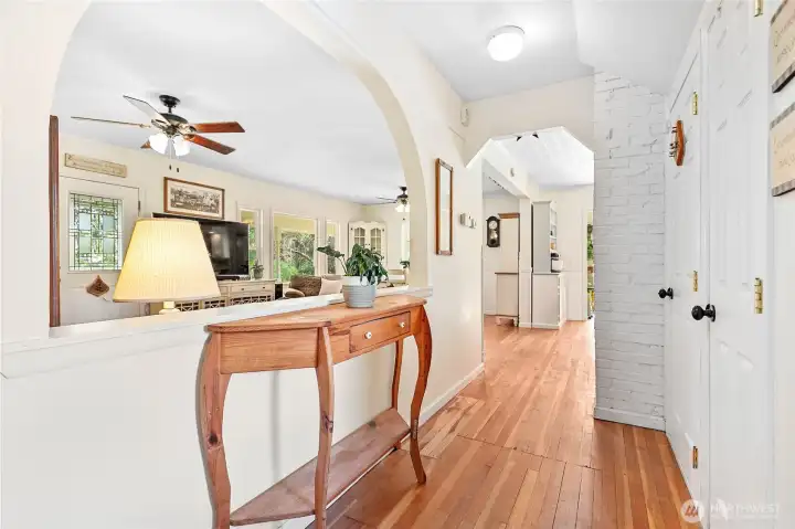 Love the arched opening between living room & main floor hall. Doors to right lead to basement & storage closet