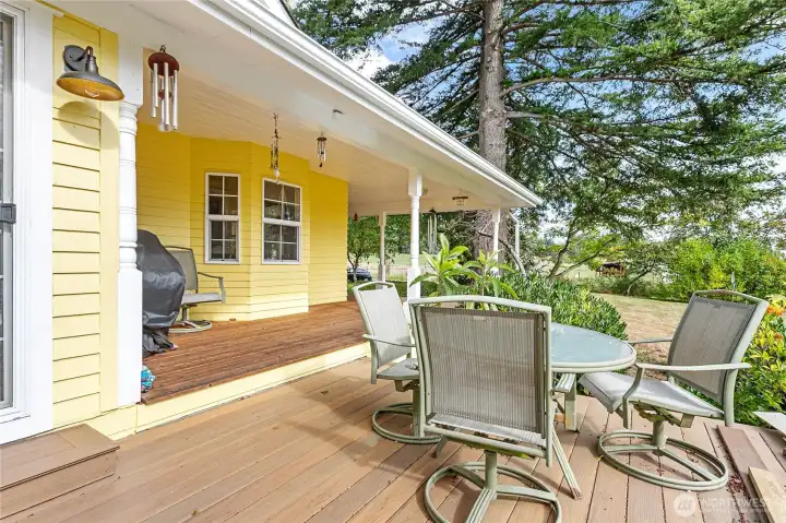 Porch wraps around from front entry to this larger deck off sunroom