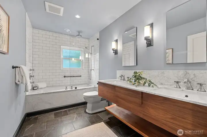 Soapstone floors with marble countertops complete this remodeled bathroom