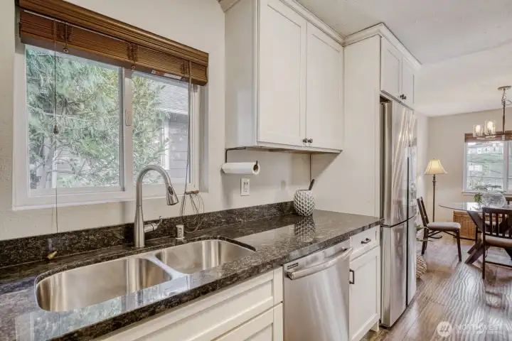 Beautiful granite countertops and shaker cabinets.